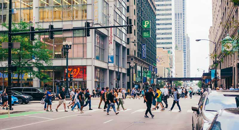 A lively city crosswalk filled with people