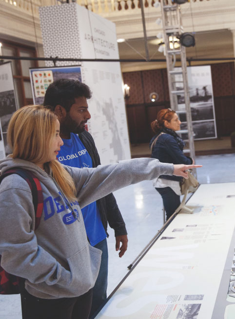 Two students observe a small model of Chicago