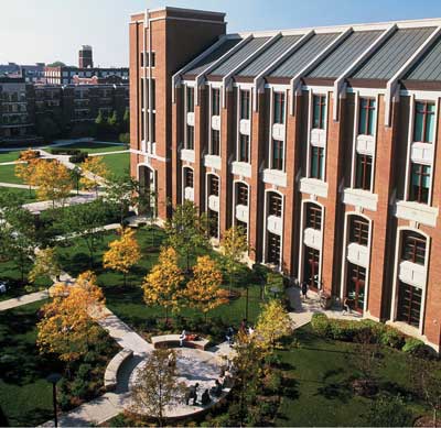 Large brick campus building and a green courtyard